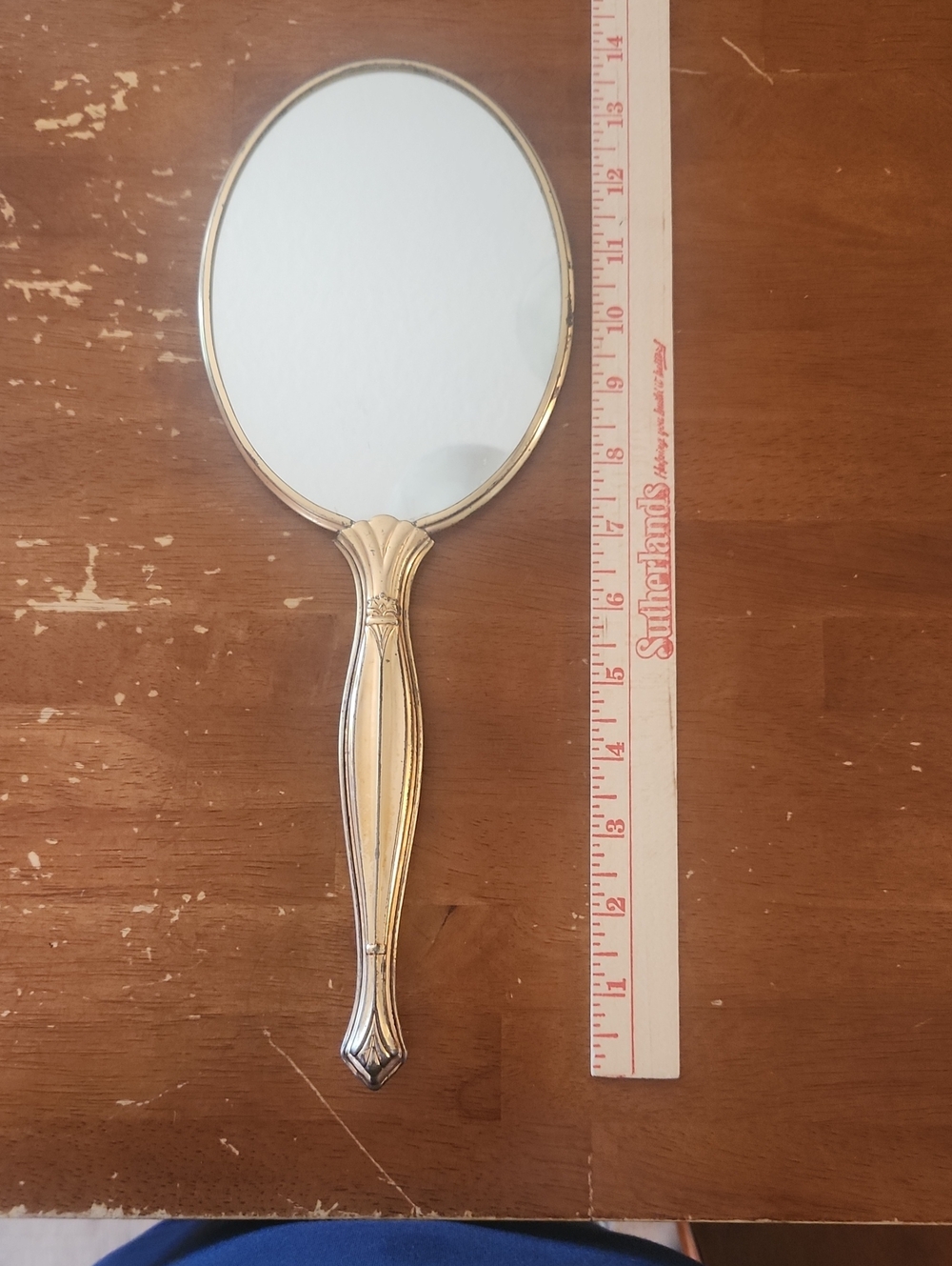vintage vanity hand mirror features floral pattern With gold/ brass-toned handle